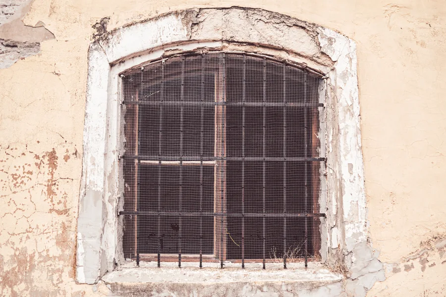 Barred Window in Ochre Wall