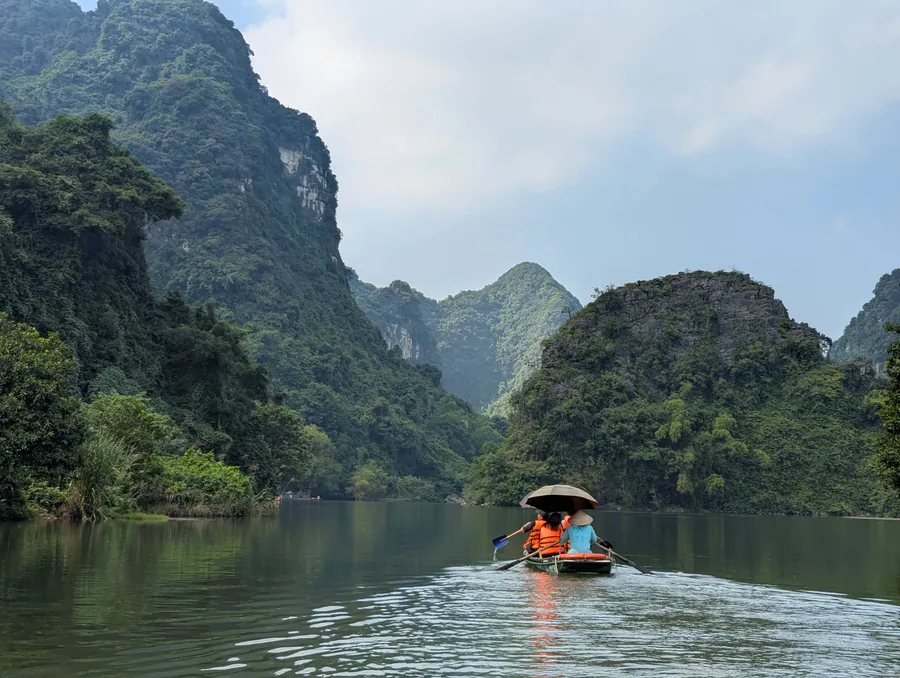 Boat Among Vietnam's Karst Peaks